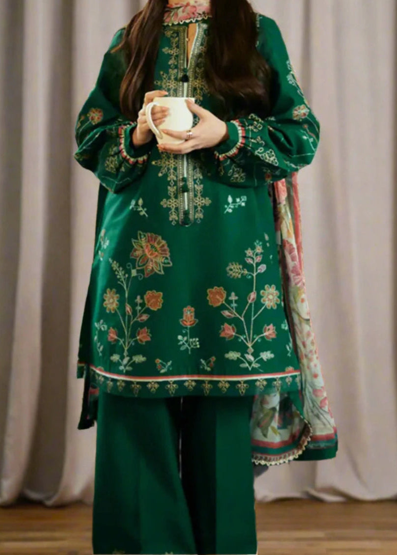 green embroidered traditional outfit with a plain background